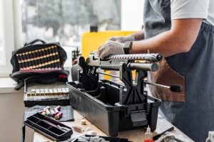 The gunsmith maintaining his rifle in a workshop
