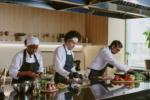 Multiracial cooking team working together in restaurant kitchen, they preparing ingredients