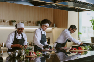 Multiracial cooking team working together in restaurant kitchen, they preparing ingredients