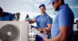 Diverse group of workers install air conditioner in commercial building.