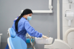 Dentist preparing equipment for patient in dental clinic