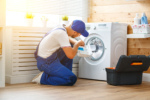 appliance repair tech repairs a washing machine